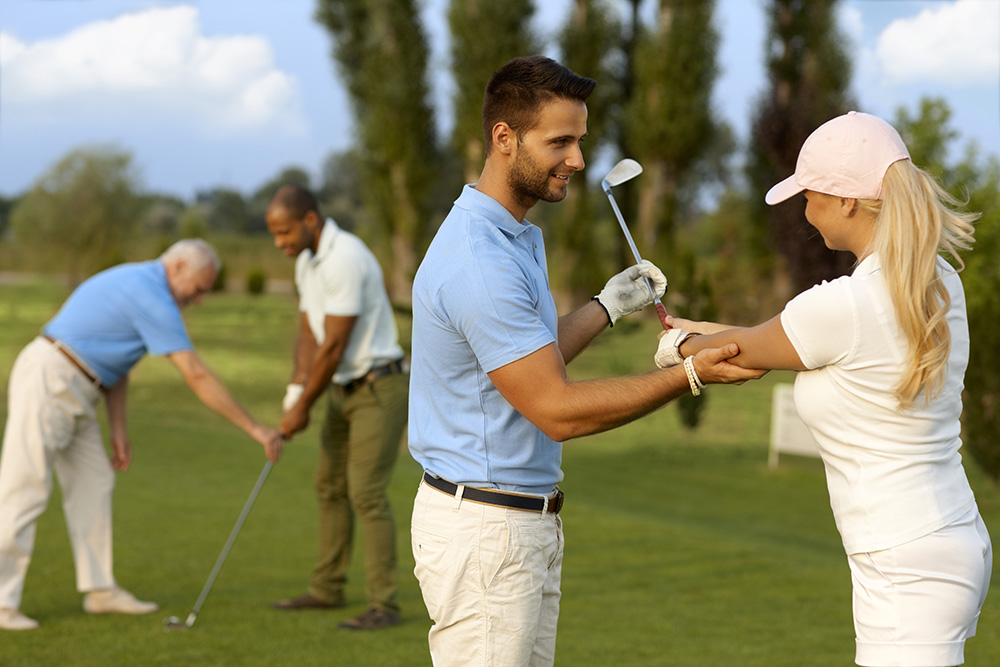 People receiving golf lessons
